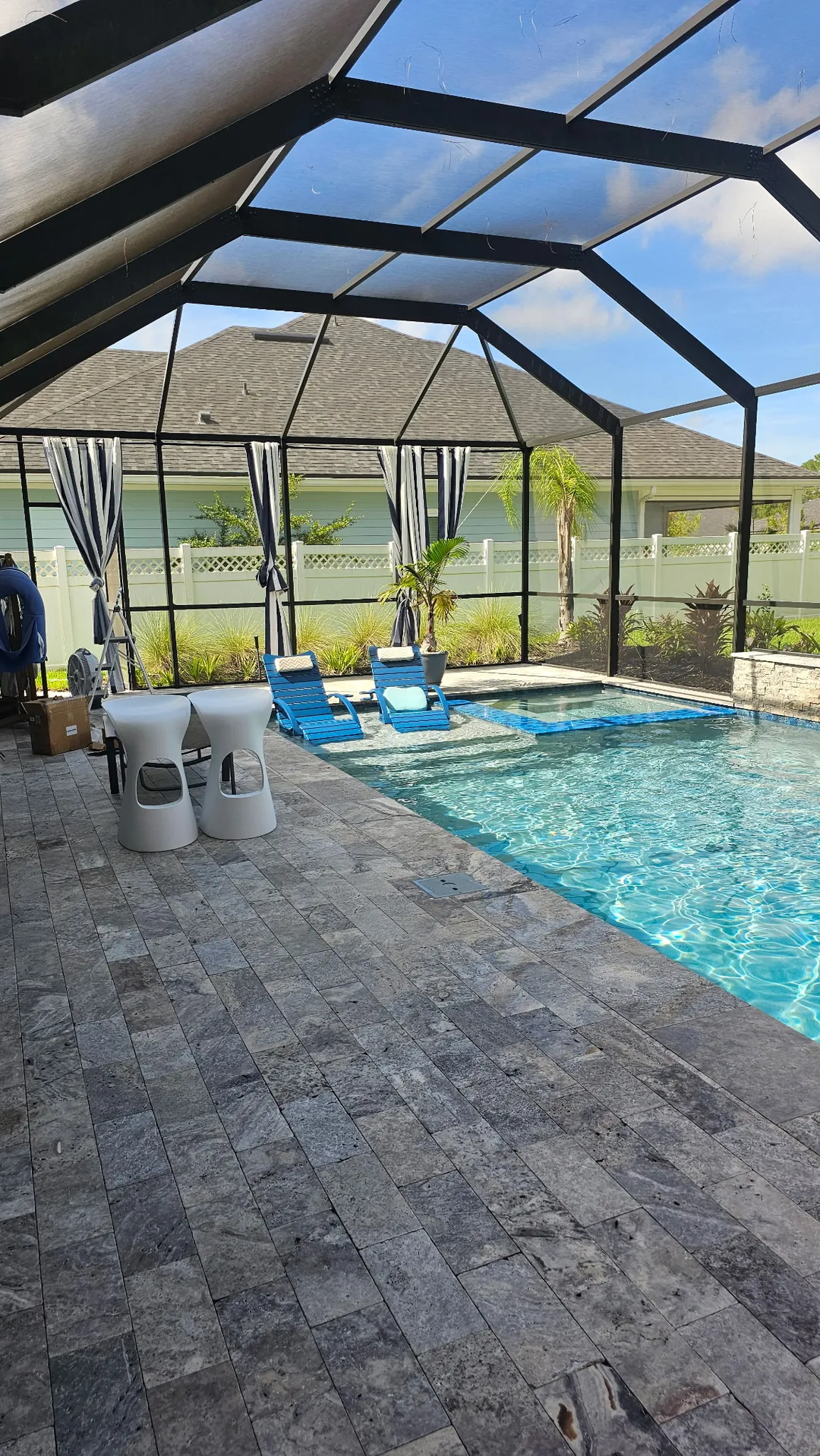 The enclosure in daylight before the install, pool and loungers