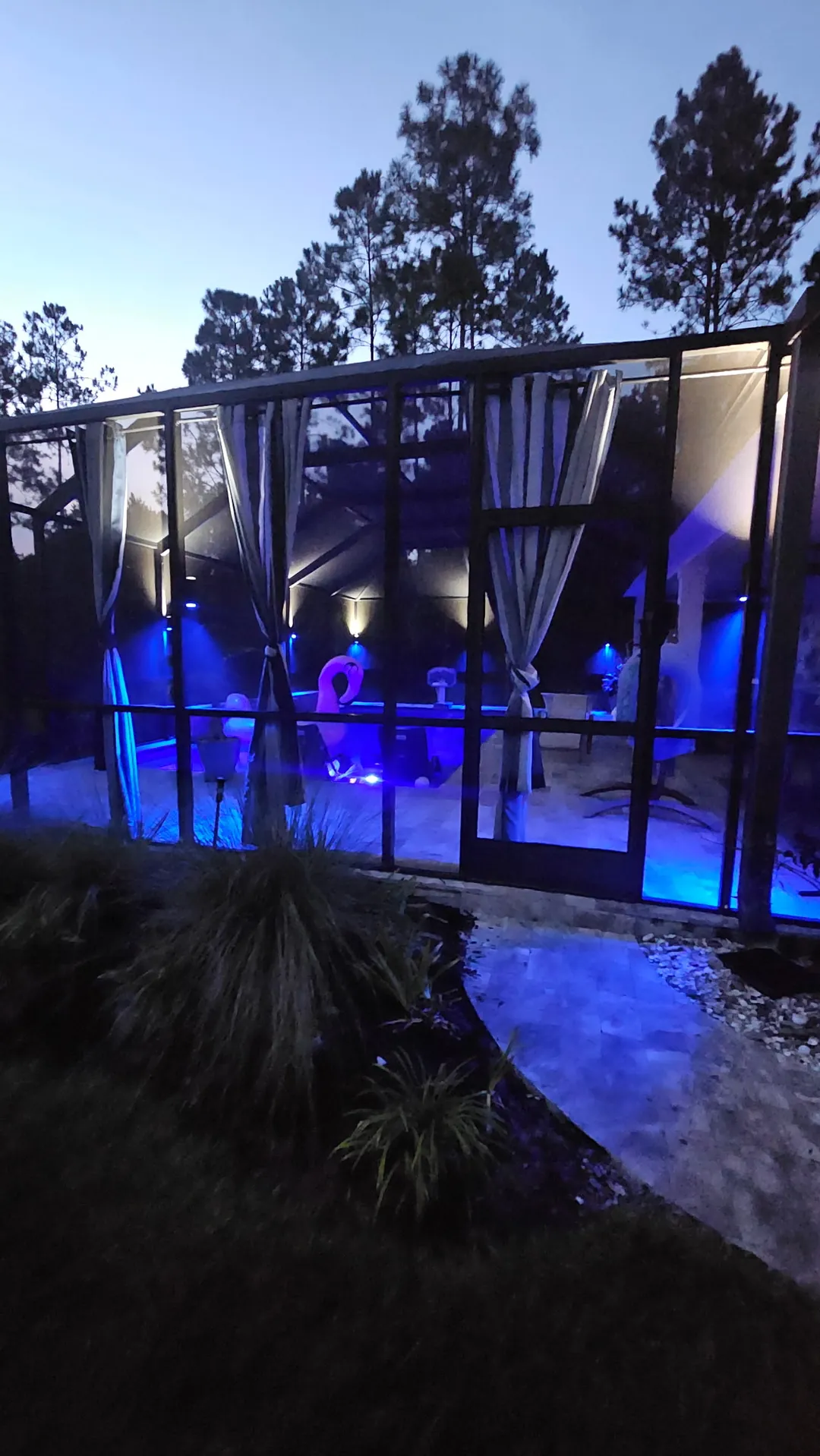 Frame sconces and landscape light around the blue pool