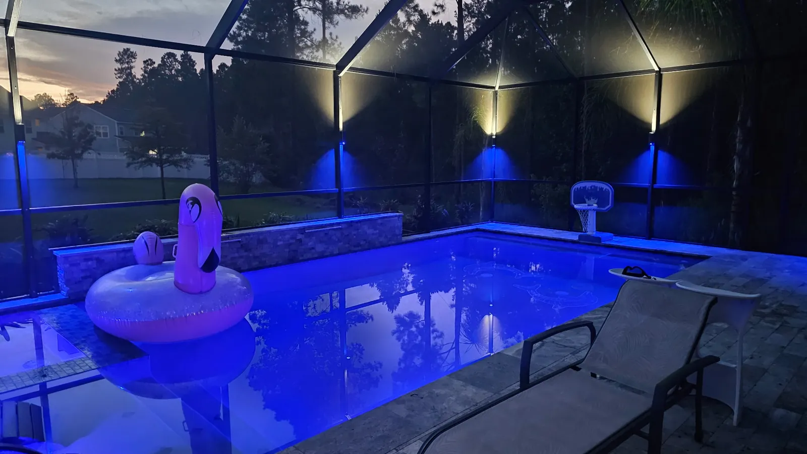 The pool lit blue, float still in the water