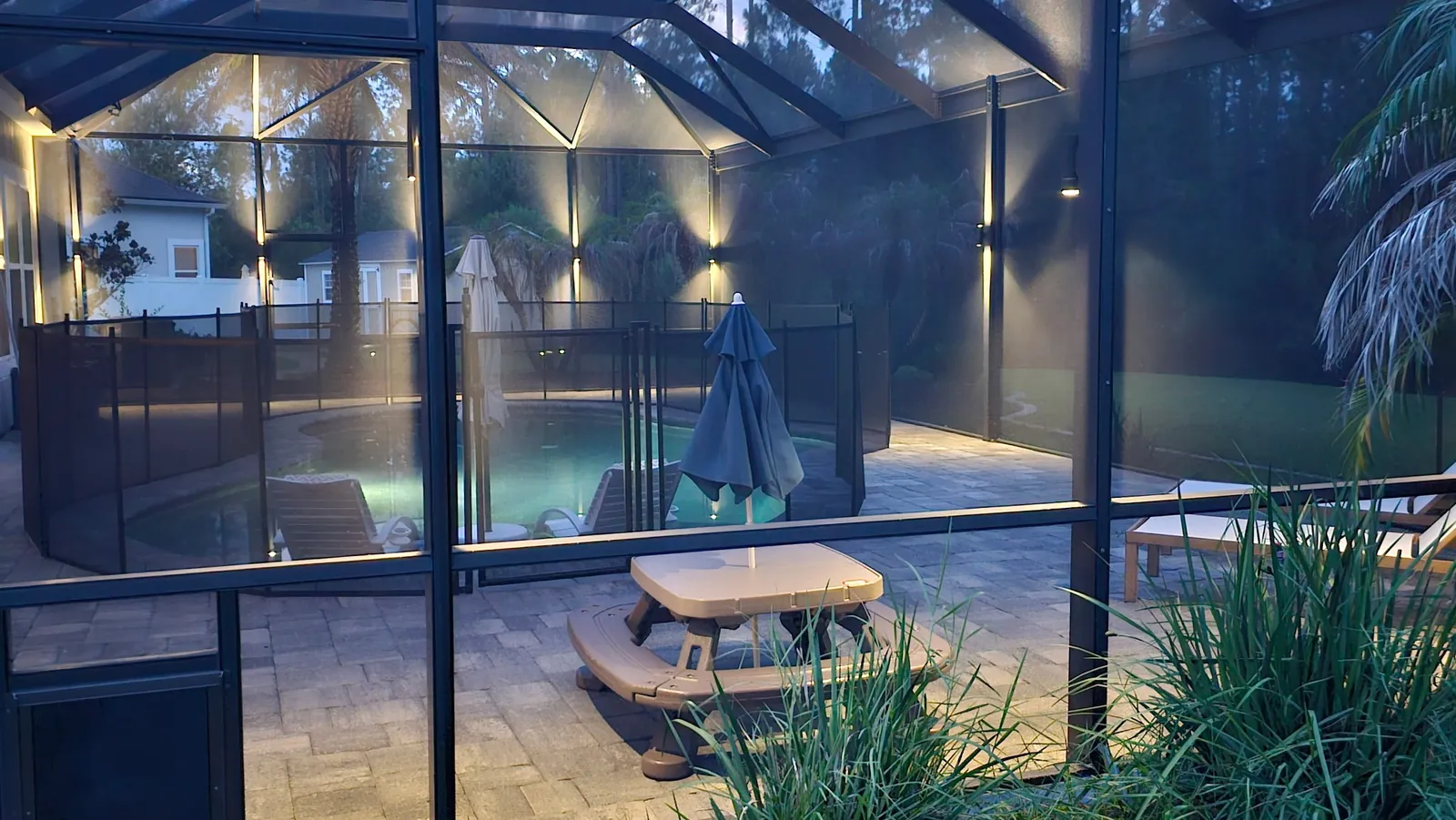 Dusk falling over the pool, lights just on