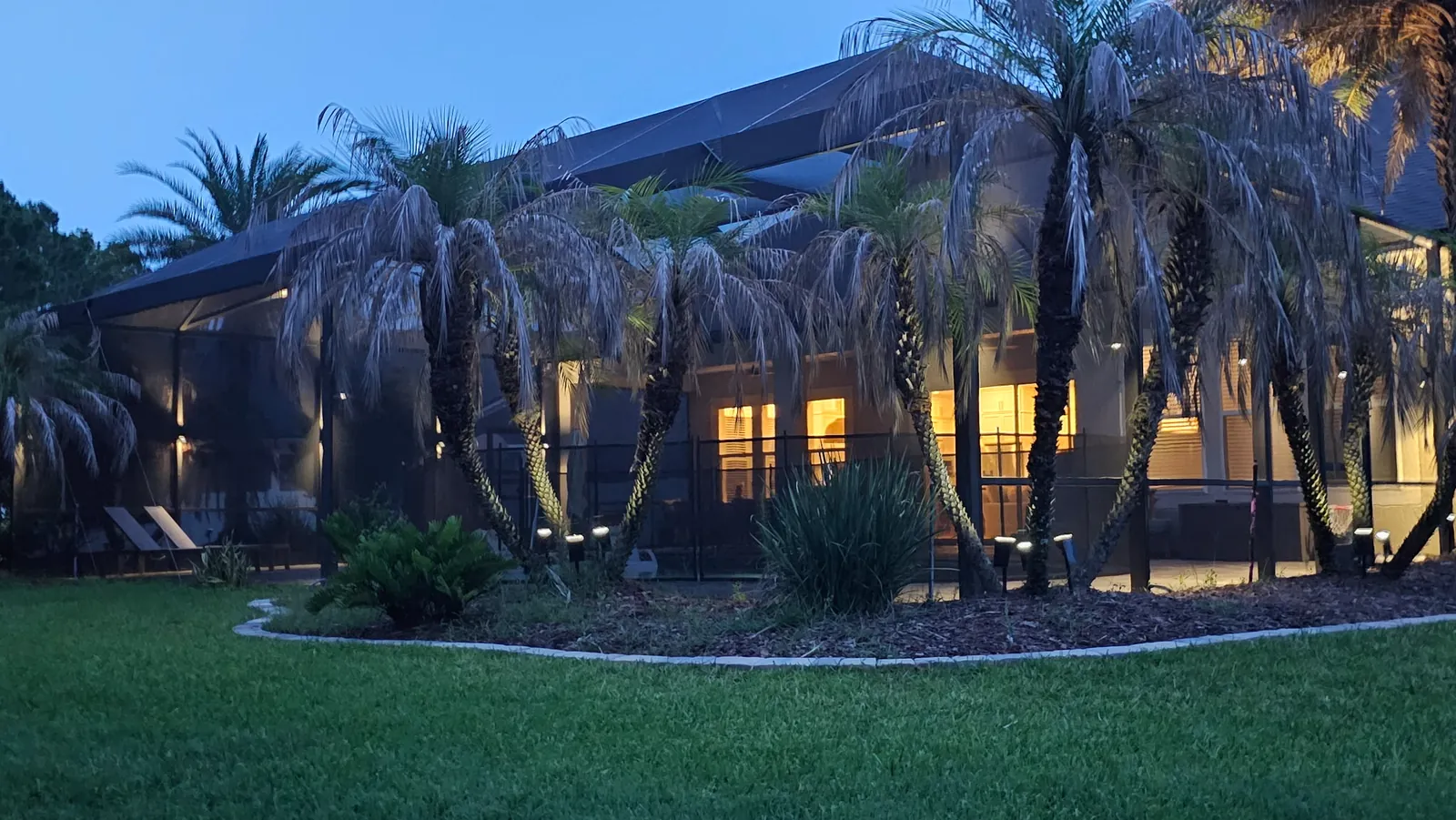 The house across the lawn, landscape lit